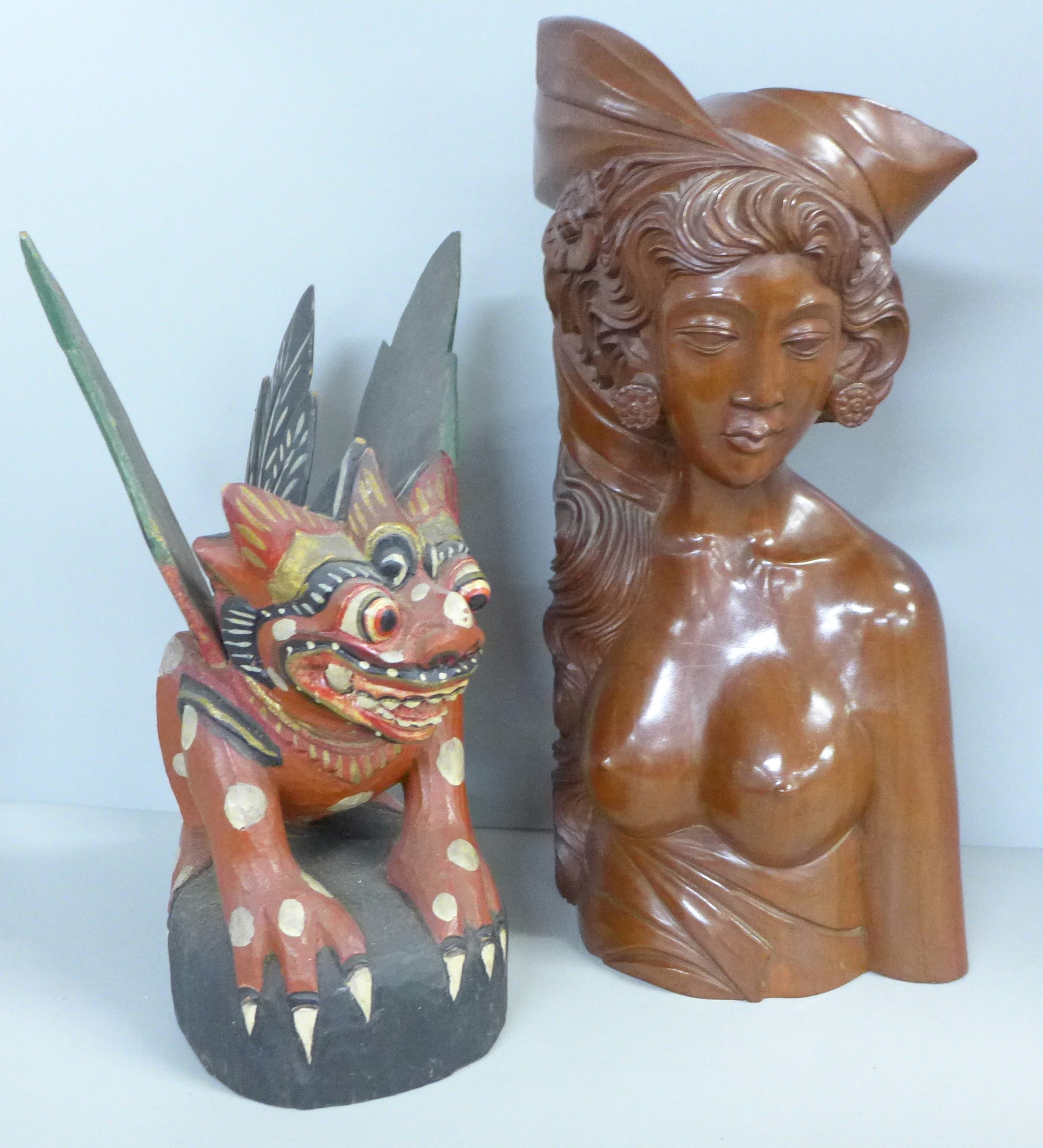 A carved wooden bust of a South East Asian girl and a Chinese painted carving of a dragon
