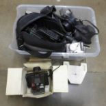 A box of cameras including basic 35mm cameras, a Canon Powershot G2 digital camera, Polaroid