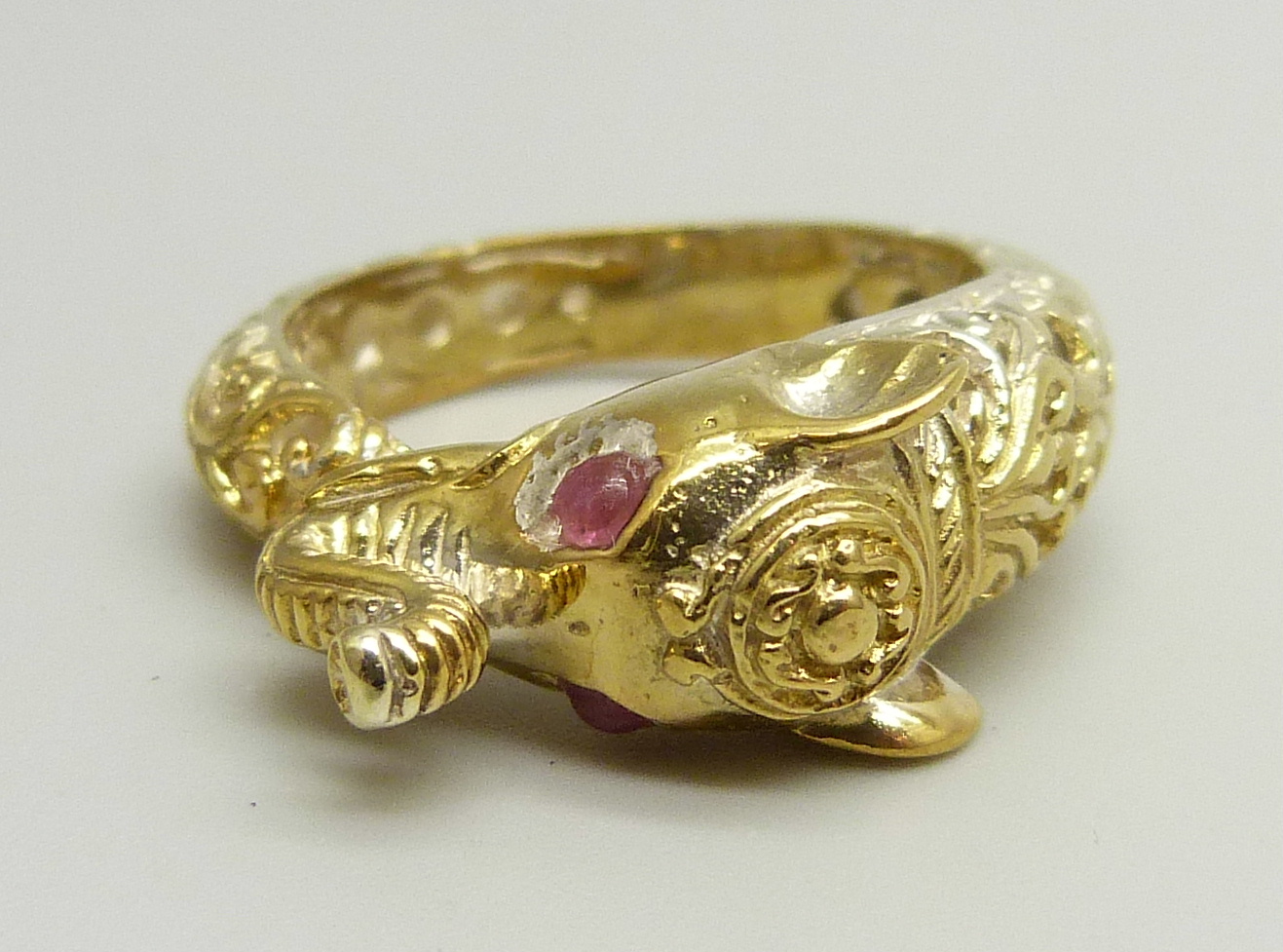 A silver gilt ring in the form of an elephant, set with red spinel eyes, P