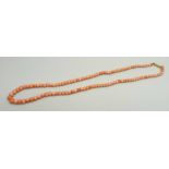 A graduated coral necklace, the clasp marked 9ct, 39.5cm, 10.3g