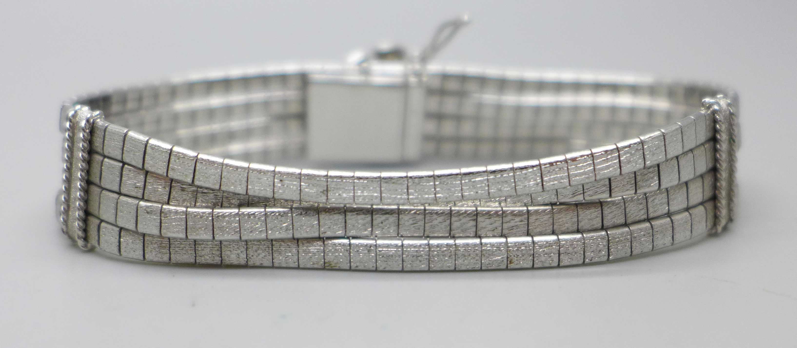 An articulated four row white metal bracelet with faux pearl centre flower fastener and safety - Image 2 of 4