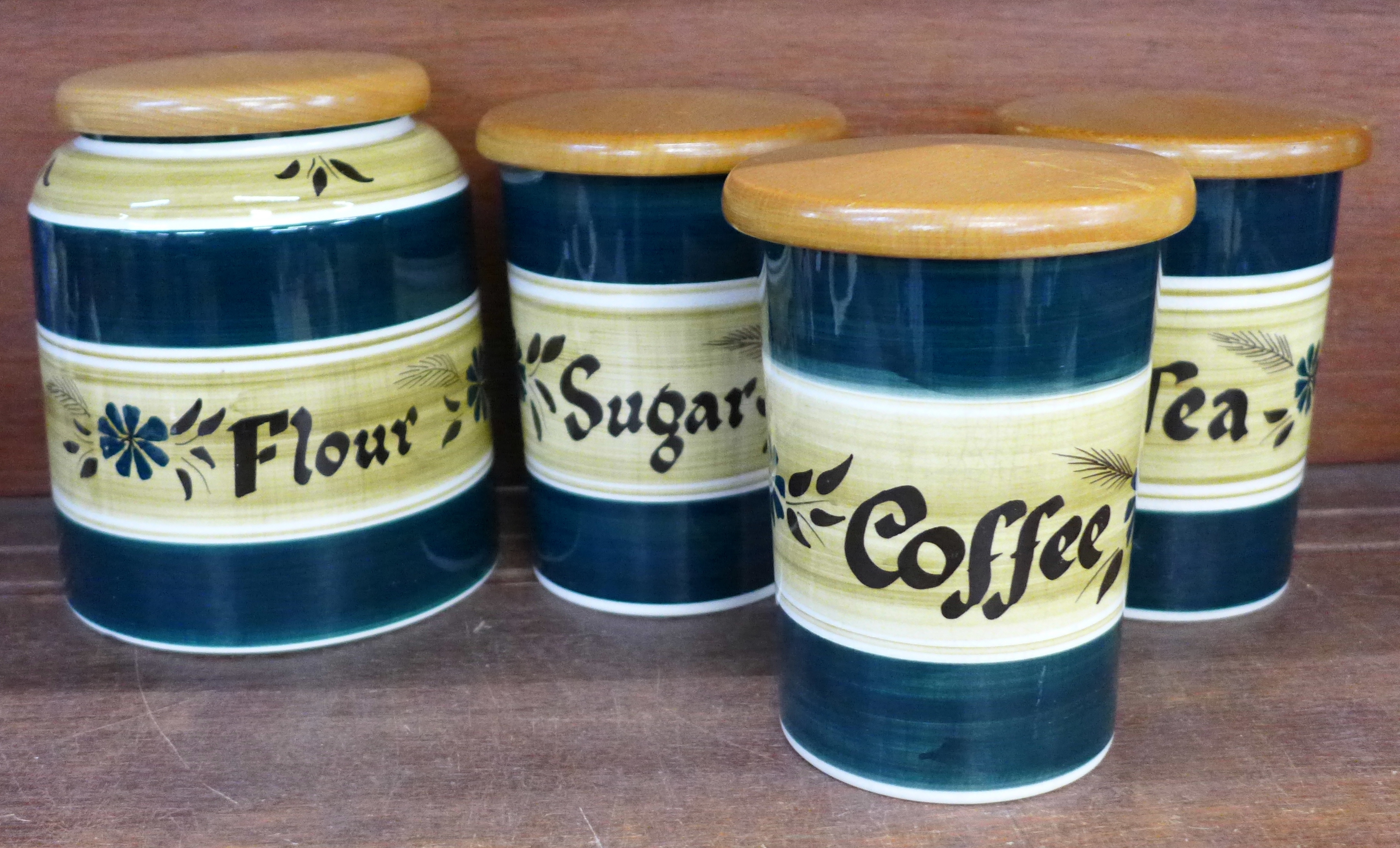 Four Tony Raymond storage jars