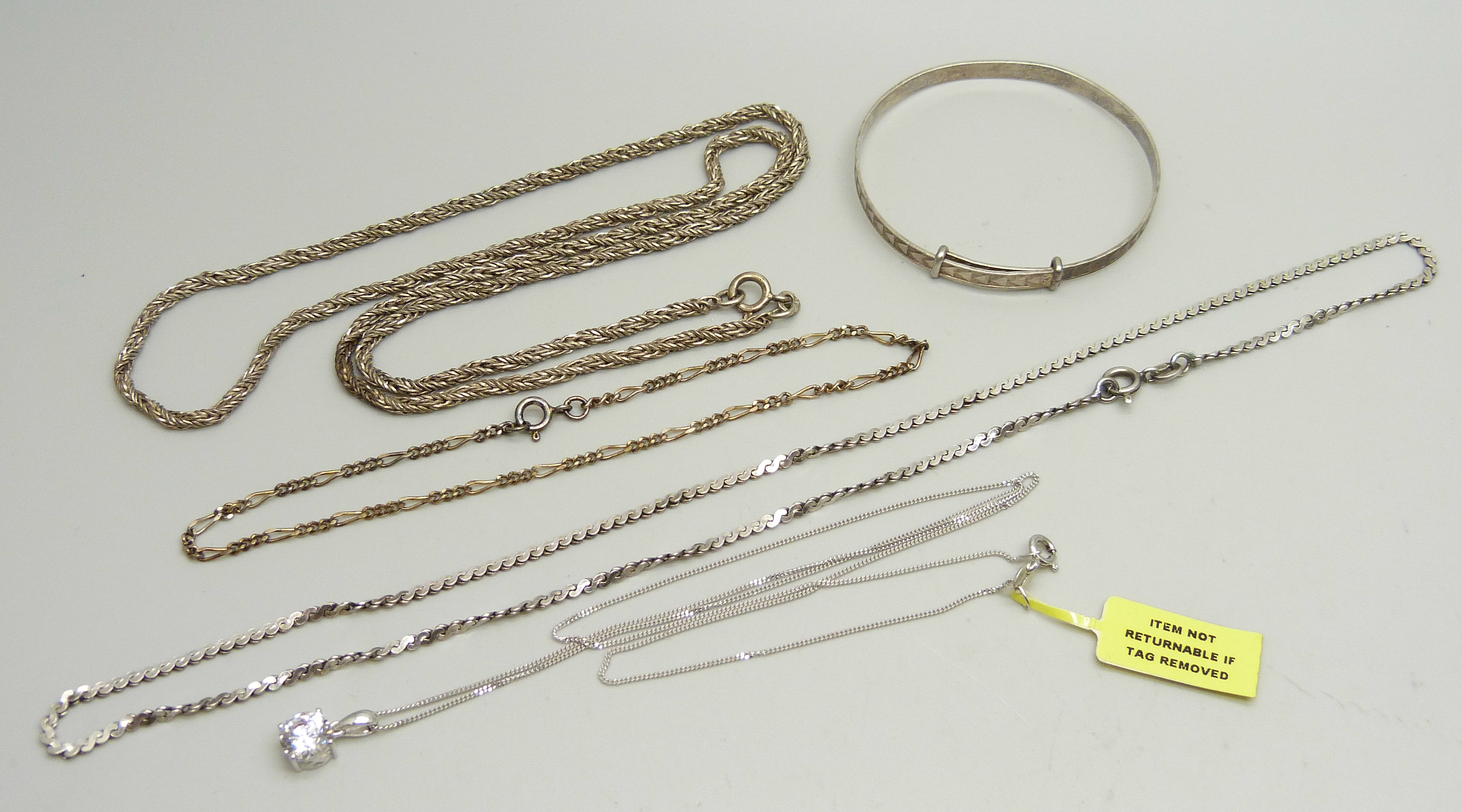 A collection of silver jewellery - a 24cm figaro bracelet, a child's bangle, a pendant and chain and