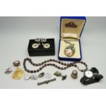 A garnet necklace, a pair of silver cufflinks, a silver cased wristwatch, a silver fox bar brooch,