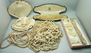 A collection of faux pearls, some boxed