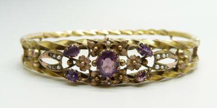 A yellow metal bangle set with purple stones and seed pearls, a/f (one pearl missing, one stone
