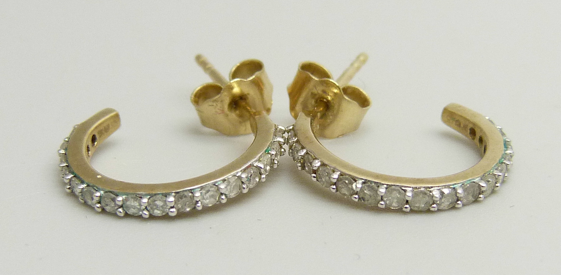 A pair of 9ct gold and diamond half hoop earrings, 1.4g