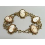 A gilt metal filigree panel bracelet set with cameos, 20.5cm, cameos 1.8 x 1.3cm, 18g