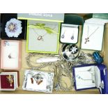 A collection of silver jewellery including three silver pendants on chains, two pairs of earrings, a