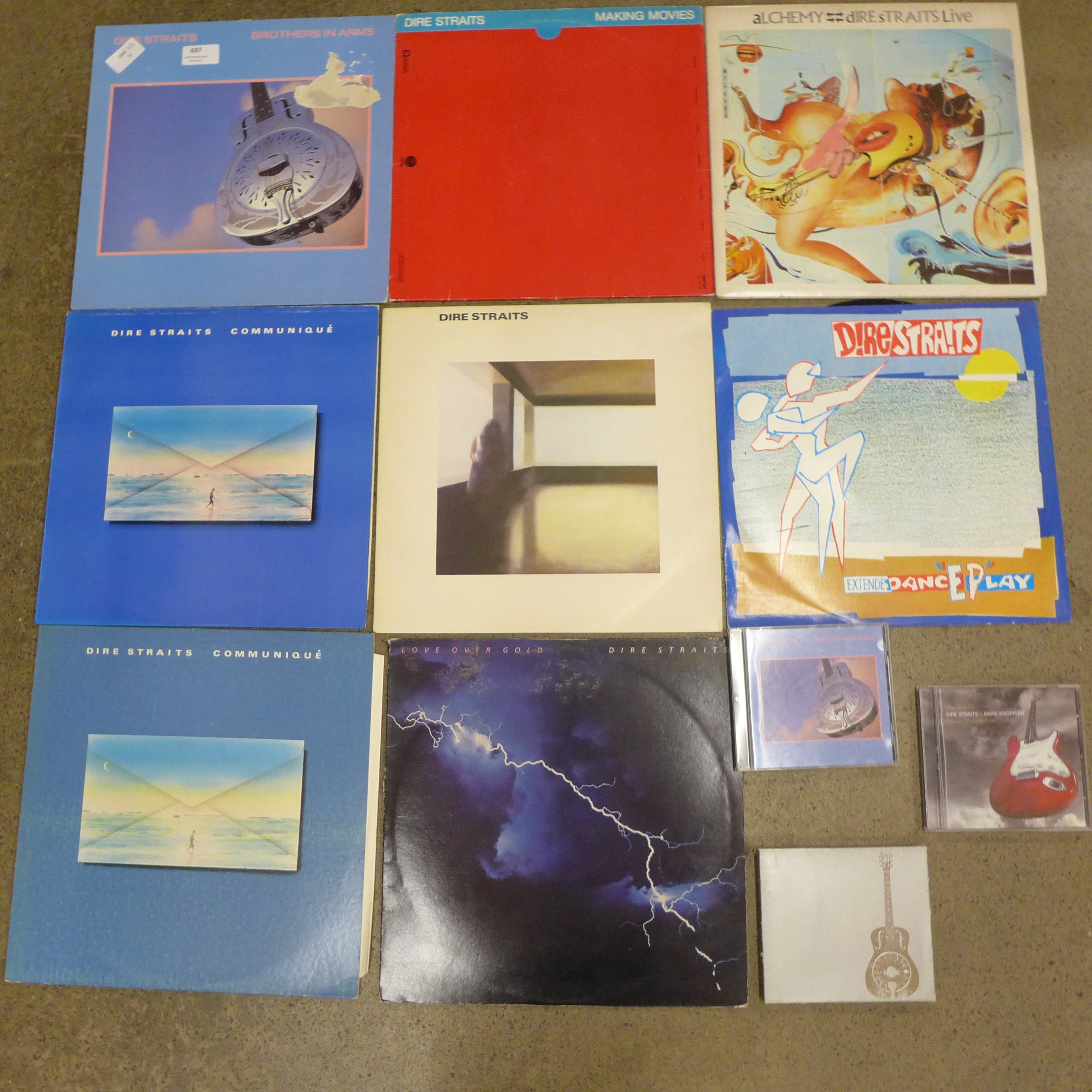 A collection of seven Dire Straits LP records, a 12" single and CDs