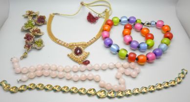 A rose quartz necklace, a large costume brooch/pendant set with rhinestones, a Claxton London