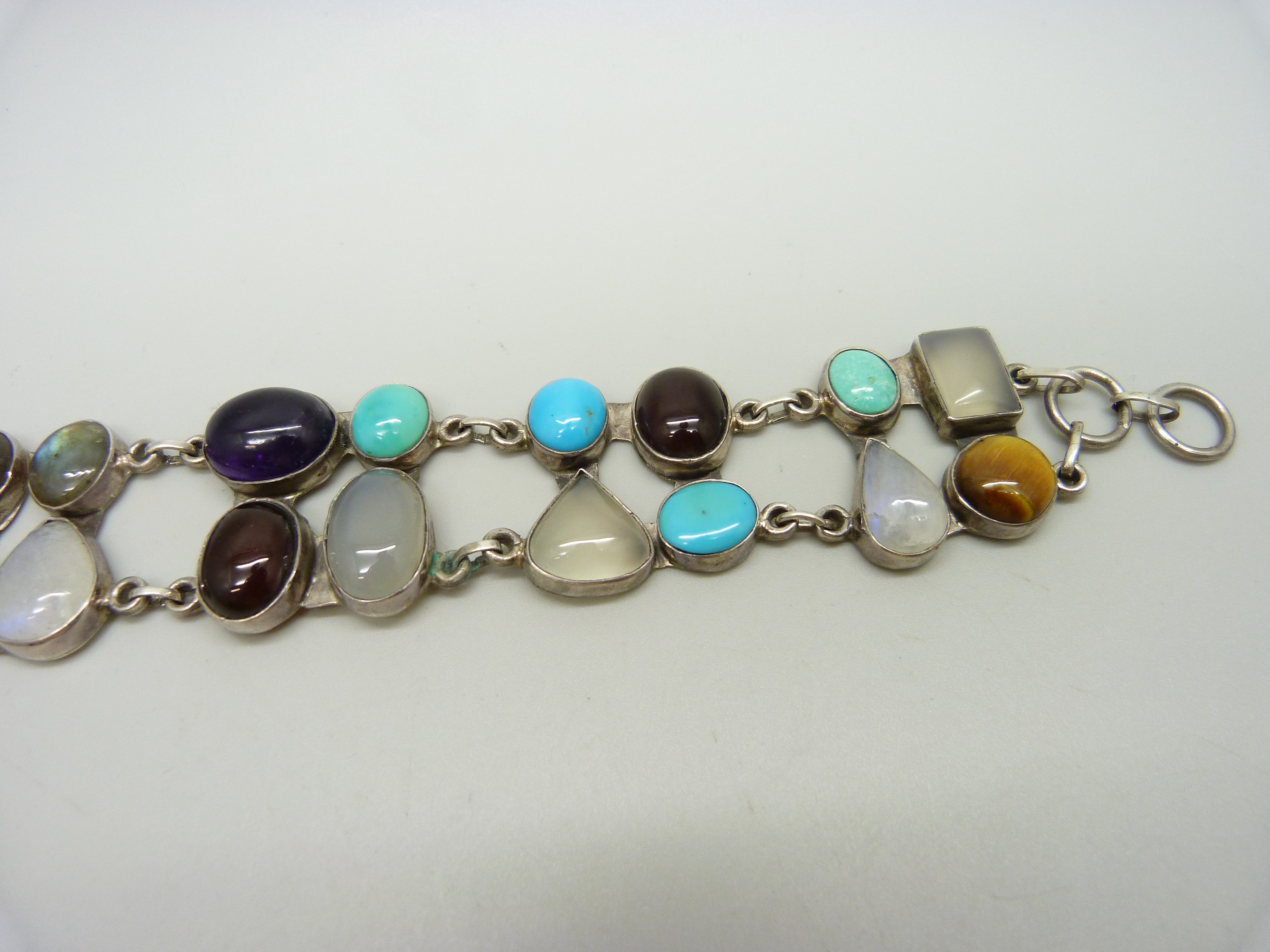 A silver bracelet set with twenty gemstones including tiger's eye, amethyst, moonstone, - Image 3 of 4