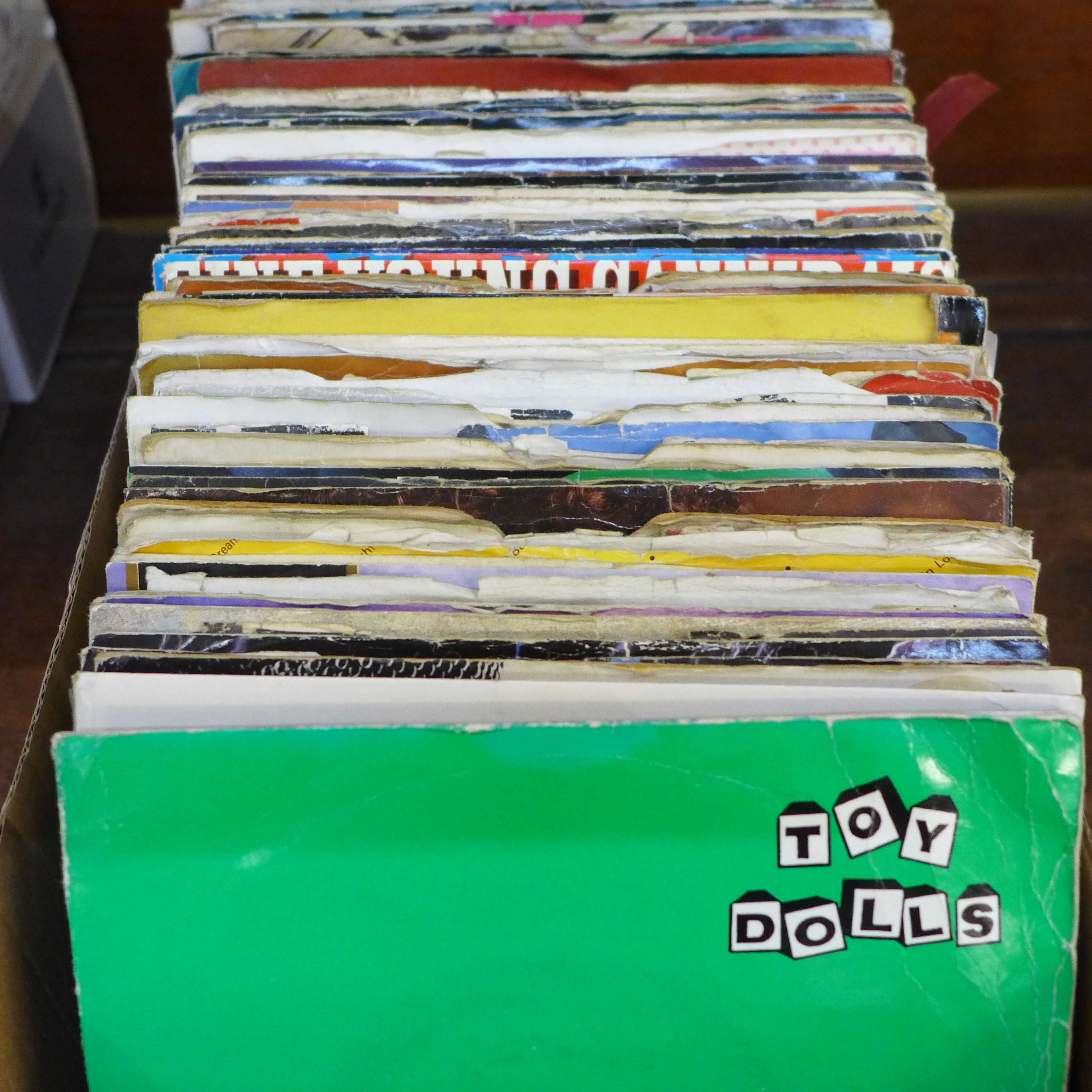 A box of 1970s/1980s 7" singles; rock, new wave, pop, etc.