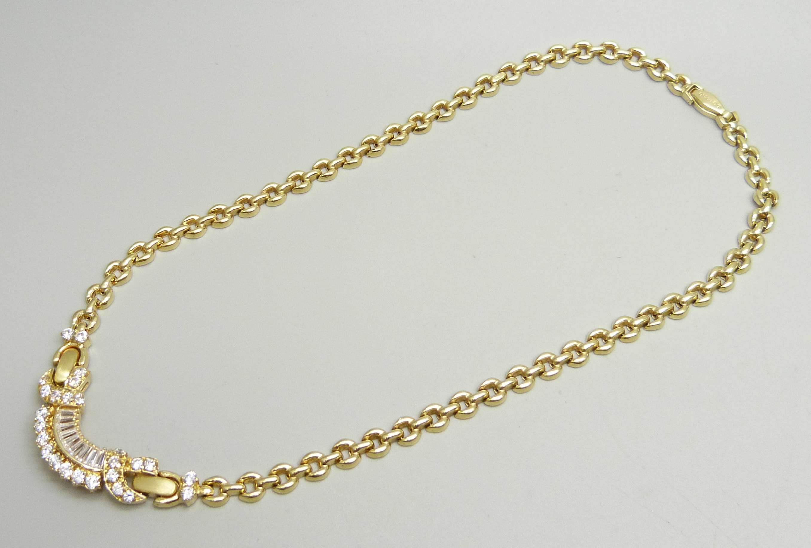 A 14ct gold and white stone set necklace, (small split in one hollow link), 25.8g