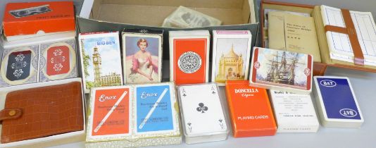 A leather cased Bridge set and a collection of playing cards (some unused)