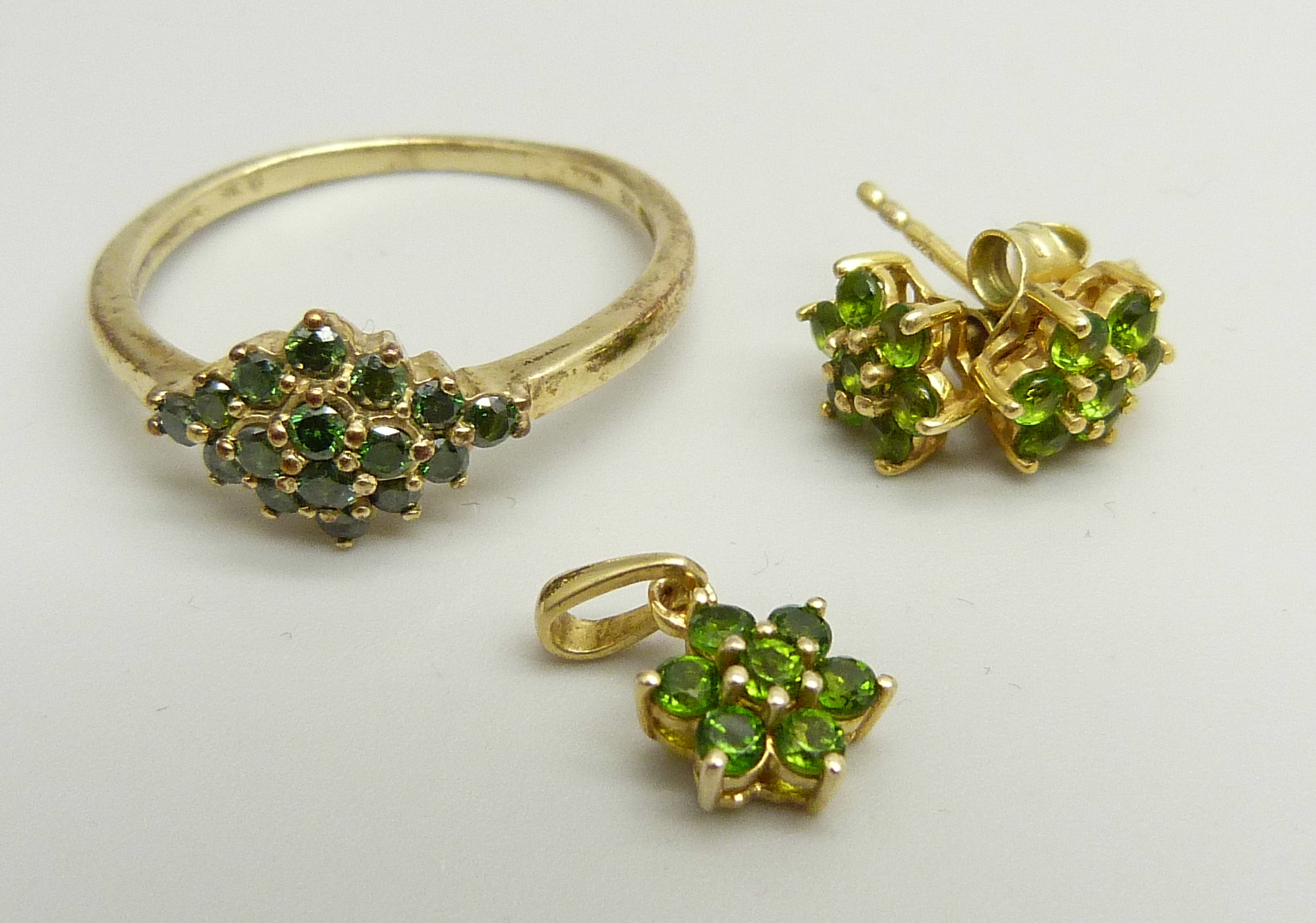 A 9ct gold and green diamond cluster ring, 2.5g, U, and a pair of silver gilt earrings and
