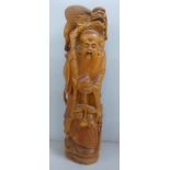 An oriental wooden carving with bone inset eyes, 39.5cm