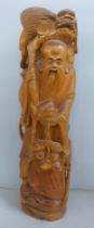 An oriental wooden carving with bone inset eyes, 39.5cm
