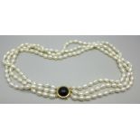 A three strand freshwater pearl necklace with a gold clasp marked 14K 585, 75g