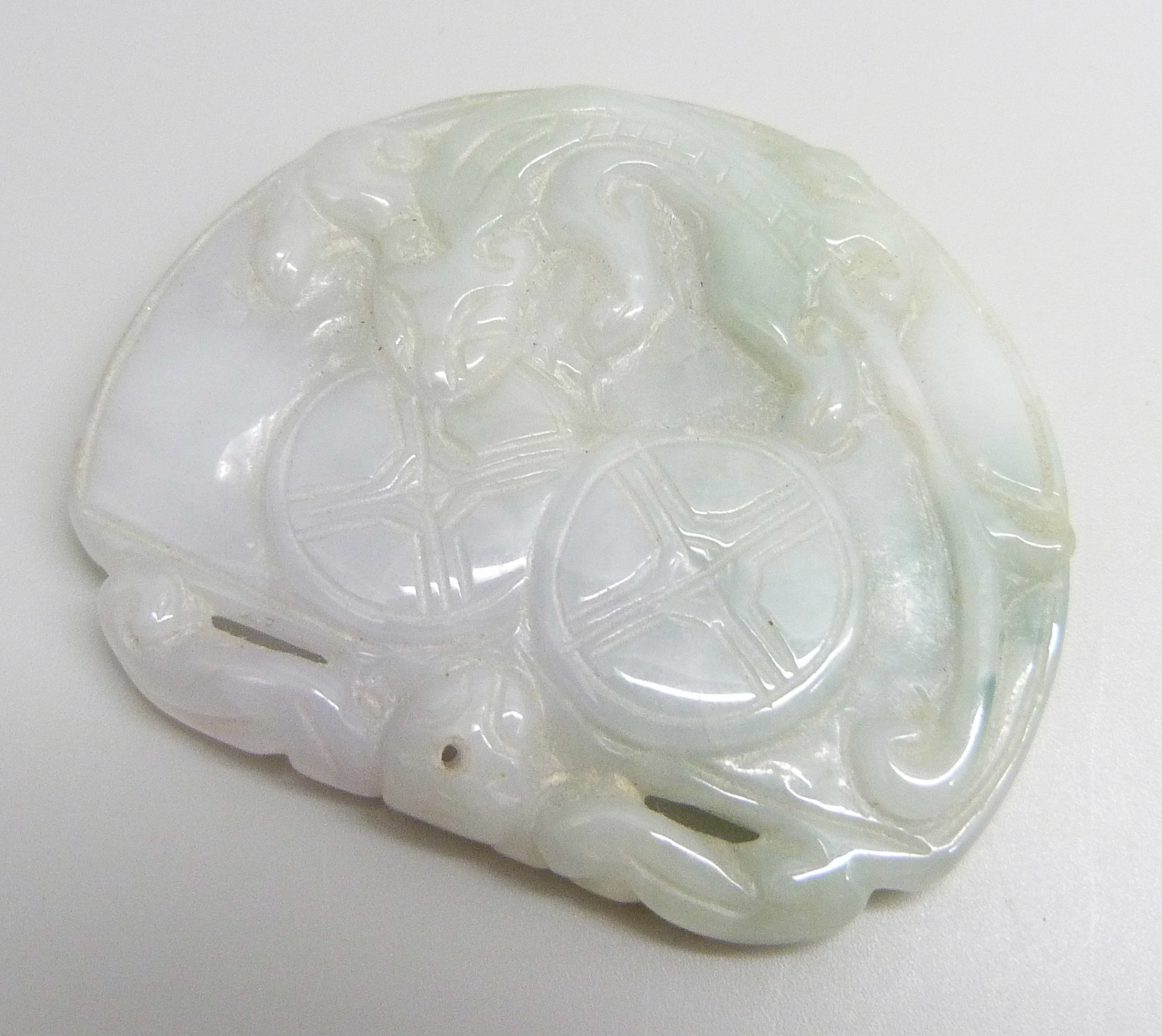 A carved jade pendant, 5.6cm x 4.6cm, 41g