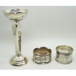 A silver posy vase, 12.5cm and two silver napkin rings, (vase with weighted base), total weight