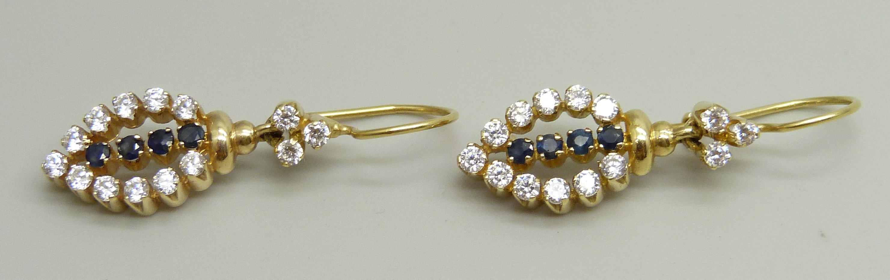 A pair of yellow metal drop earrings set with white and dark blue stones, approximately 3.6cm drop