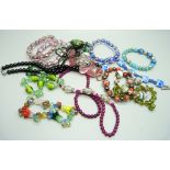 Ten glass bead and other bracelets and three necklaces