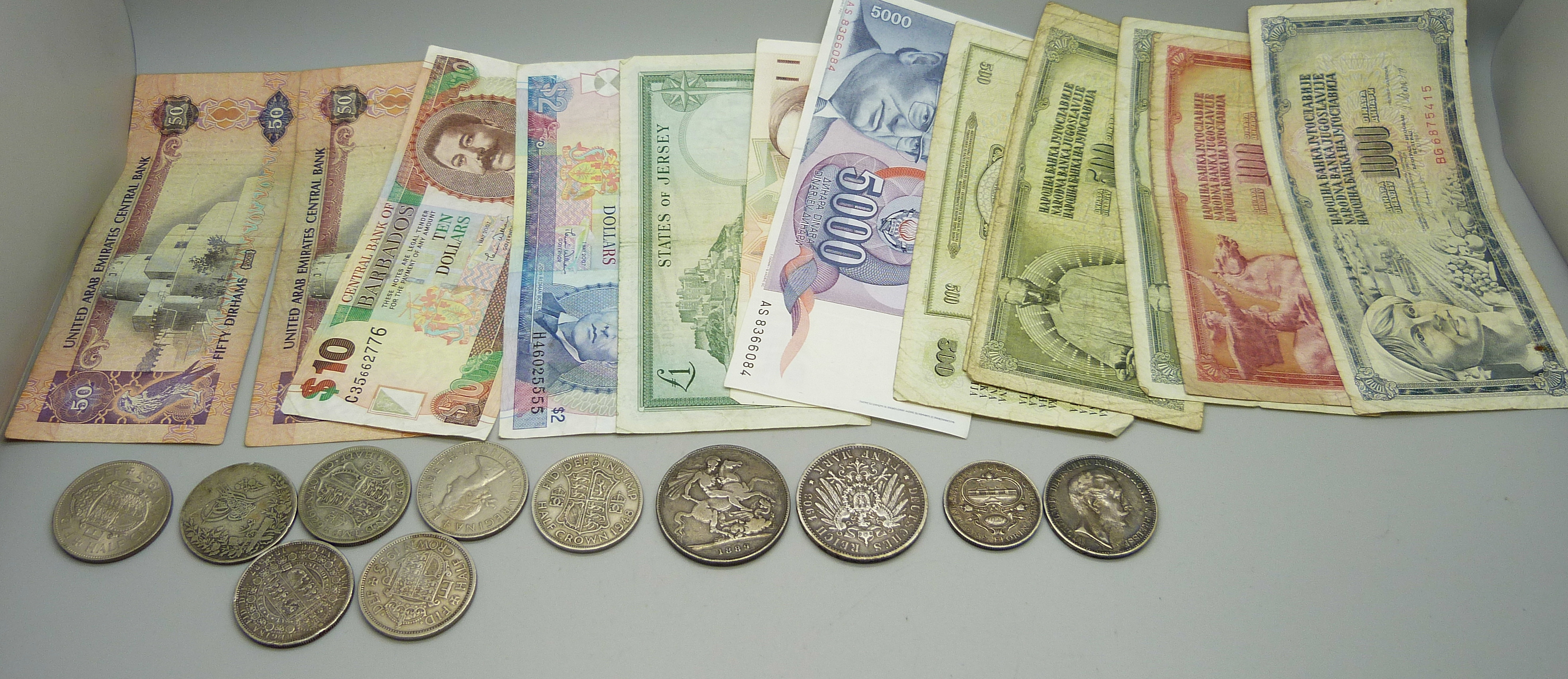 A collection of foreign bank notes, British and foreign coins including an 1889 crown and 1887