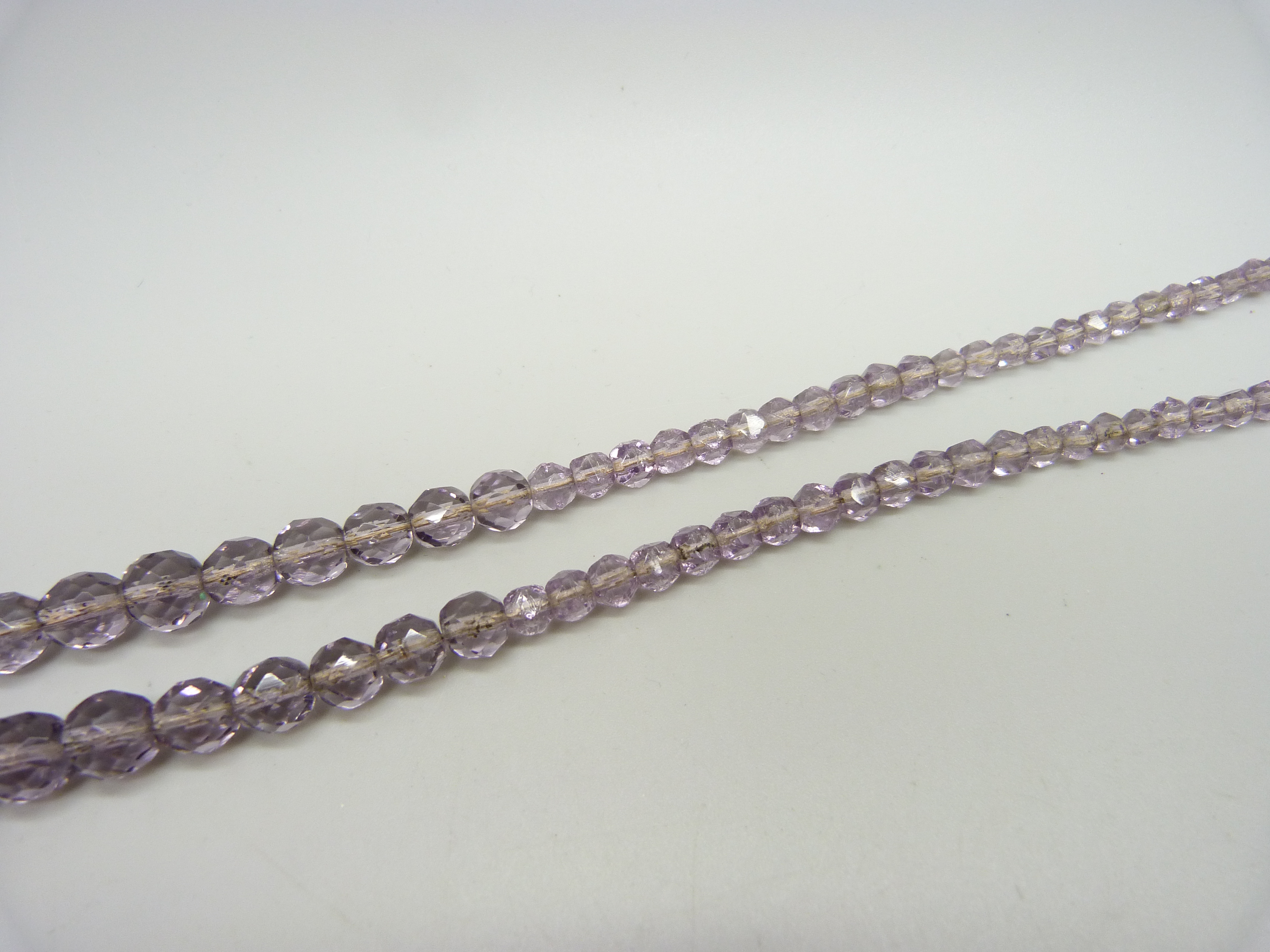 A faceted amethyst bead necklace, the bale marked 9ct, with a base metal clasp, 4.6cm pendant - Image 3 of 3