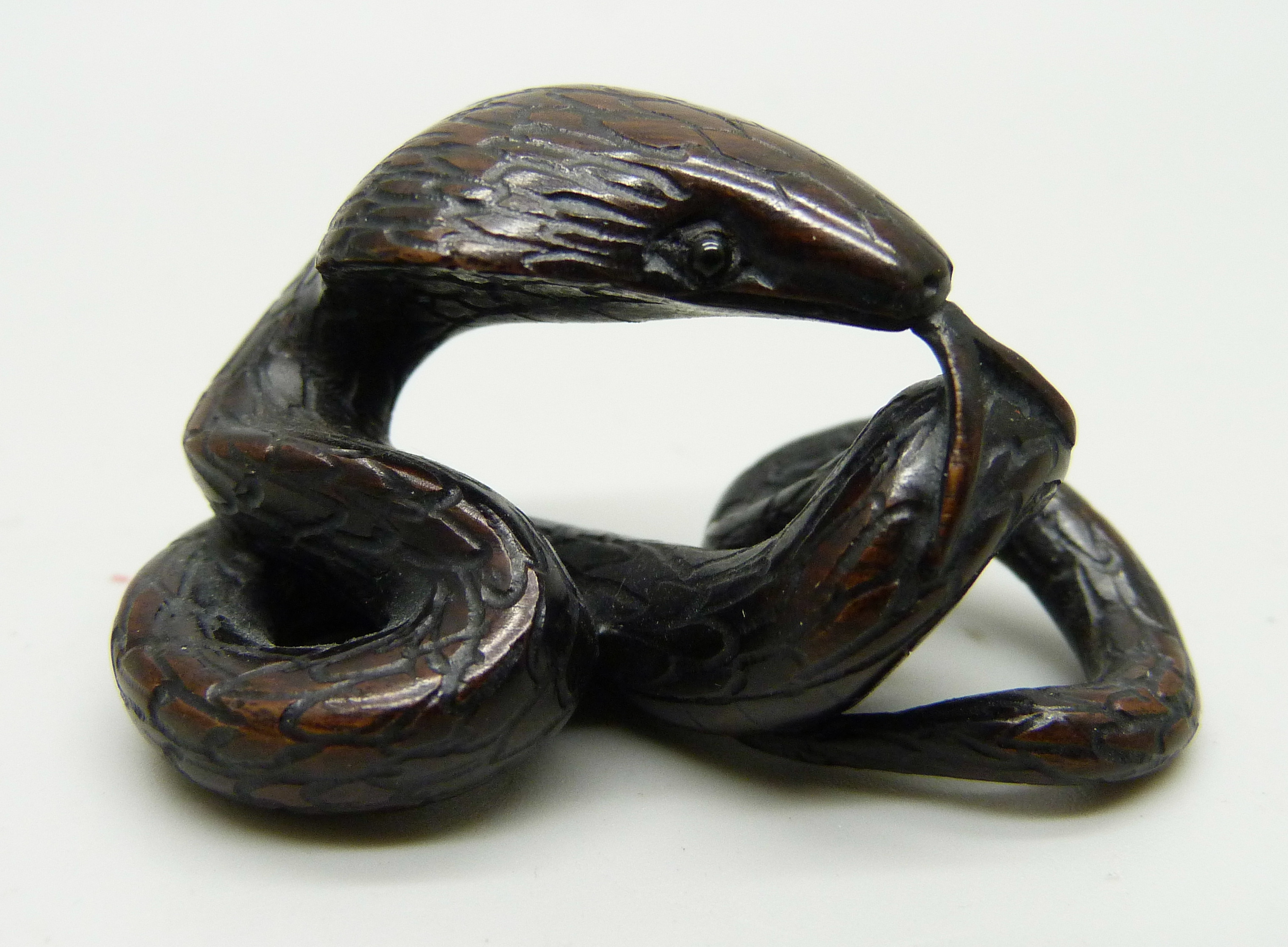 A snake netsuke, signed to base, 4.8cm long
