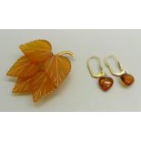 An amber coloured brooch in the form of a leaf and a pair of Baltic amber earrings