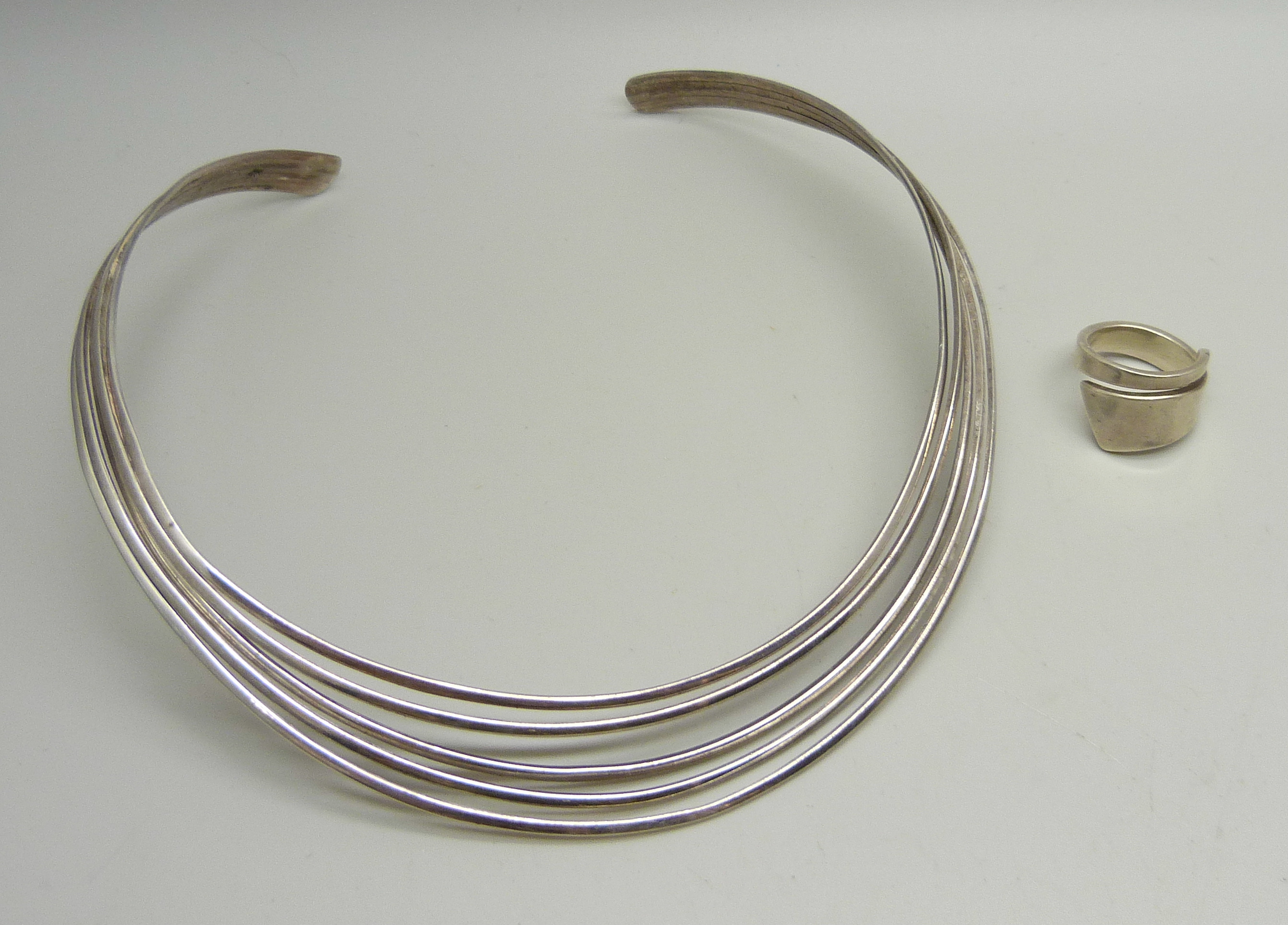 A silver torque necklace and a silver ring, M/N, 47g total