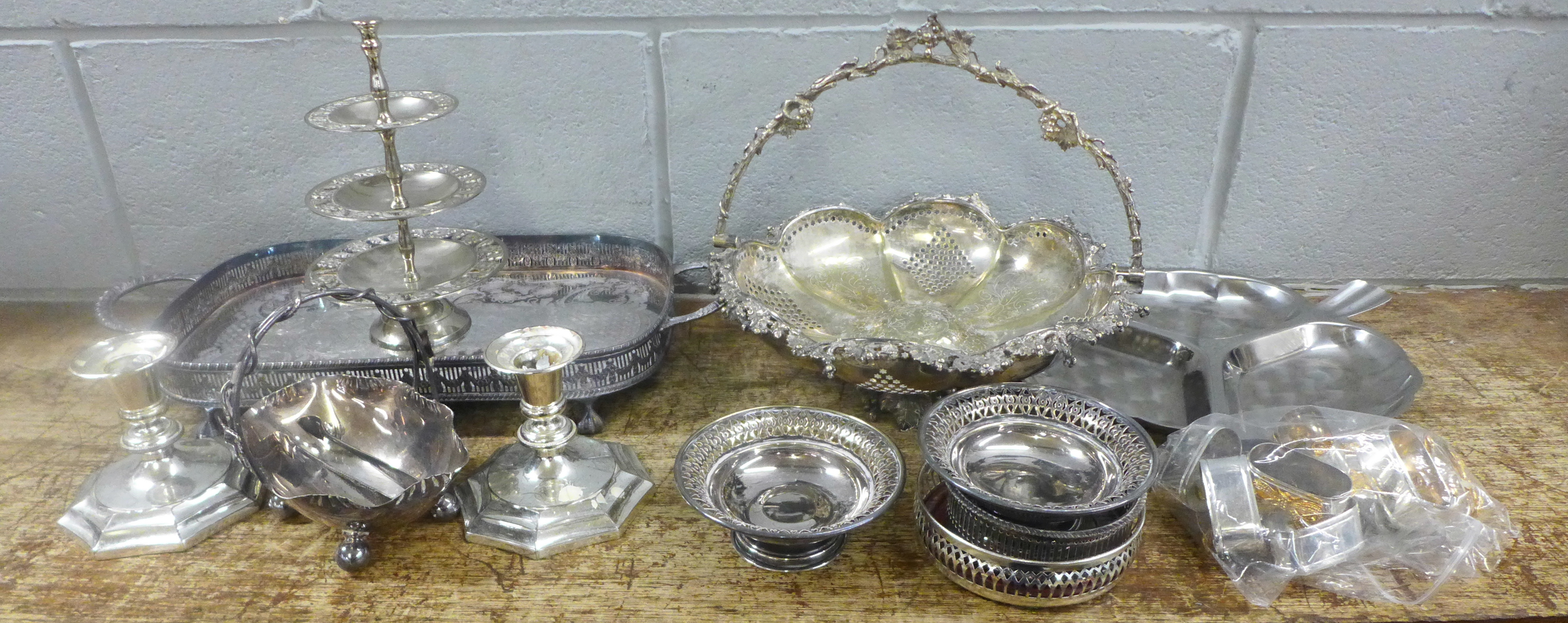 A collection of silver plated items including a gallery tray, a pair of candlesticks, an Art Nouveau