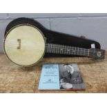 A cased banjo, marked Keech, with four George Formby EPs