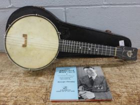 A cased banjo, marked Keech, with four George Formby EPs