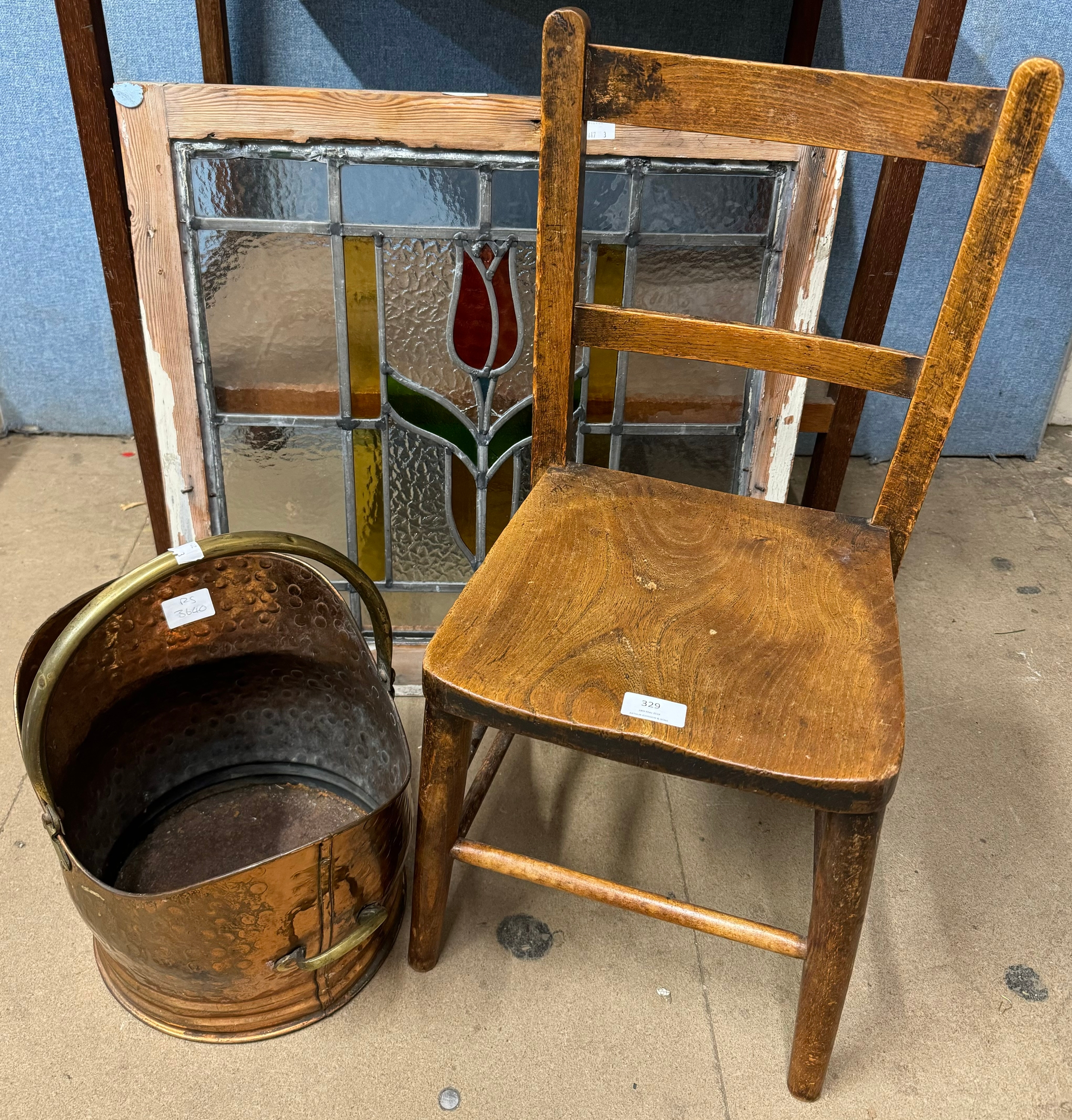 A copper coal scuttle, a child's chair and a stained glass window