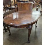 A Queen Anne style walnut oval extending dining table