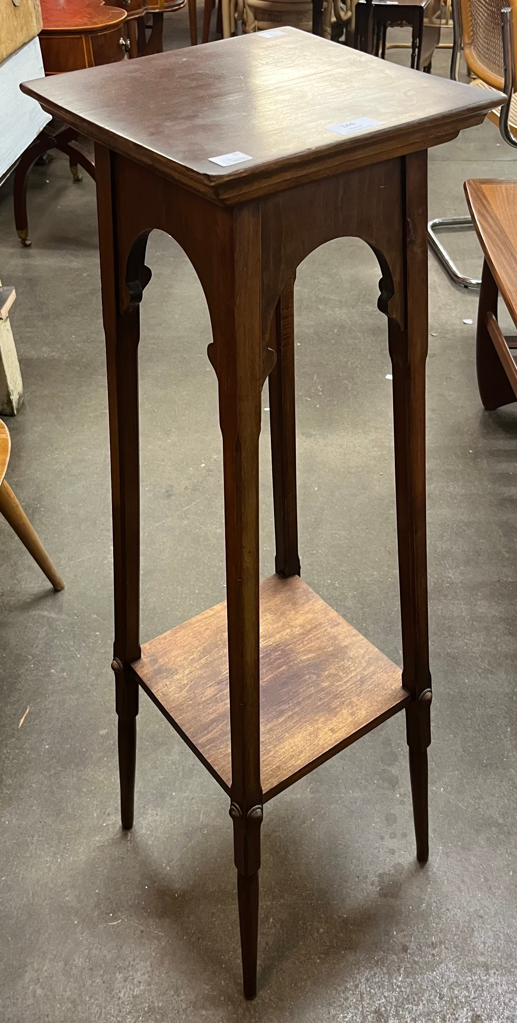 An Arts and Crafts oak jardiniere stand