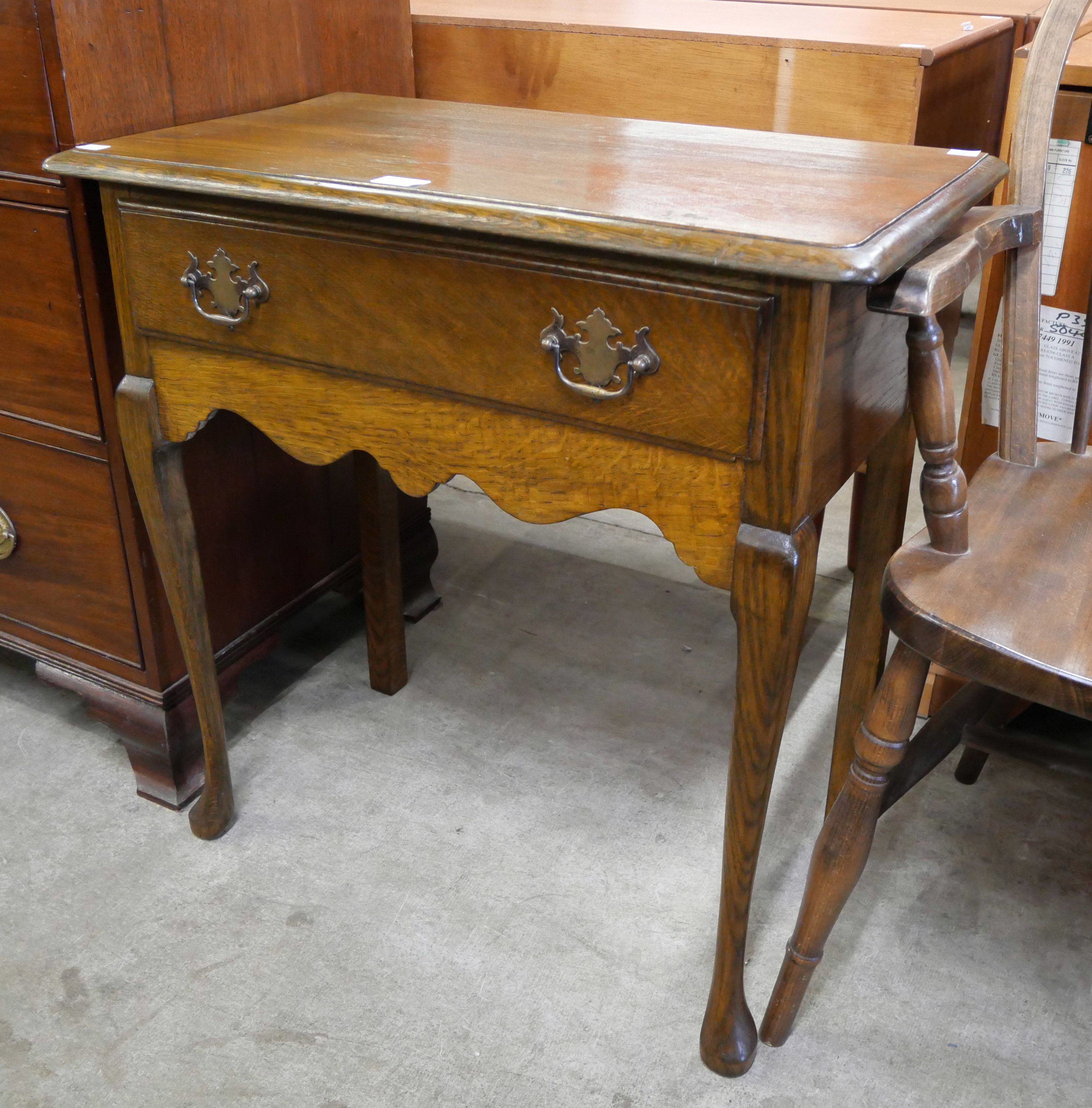 A George II style oak single drawer side table