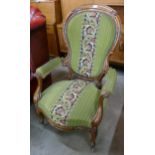 A Victorian carved walnut and fabric upholstered open armchair