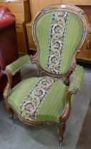 A Victorian carved walnut and fabric upholstered open armchair