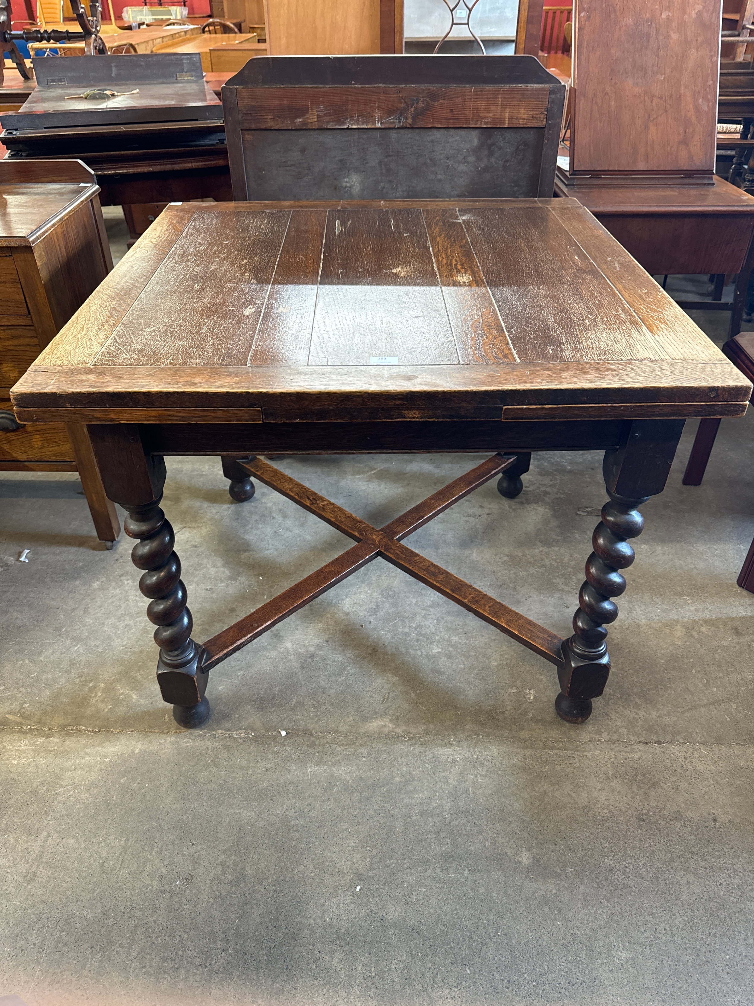 An early 20th Century oak barleytwist draw-leaf table