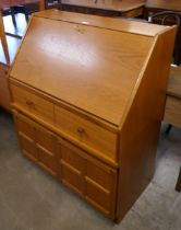 A Nathan teak bureau and a teak stereo cabinet