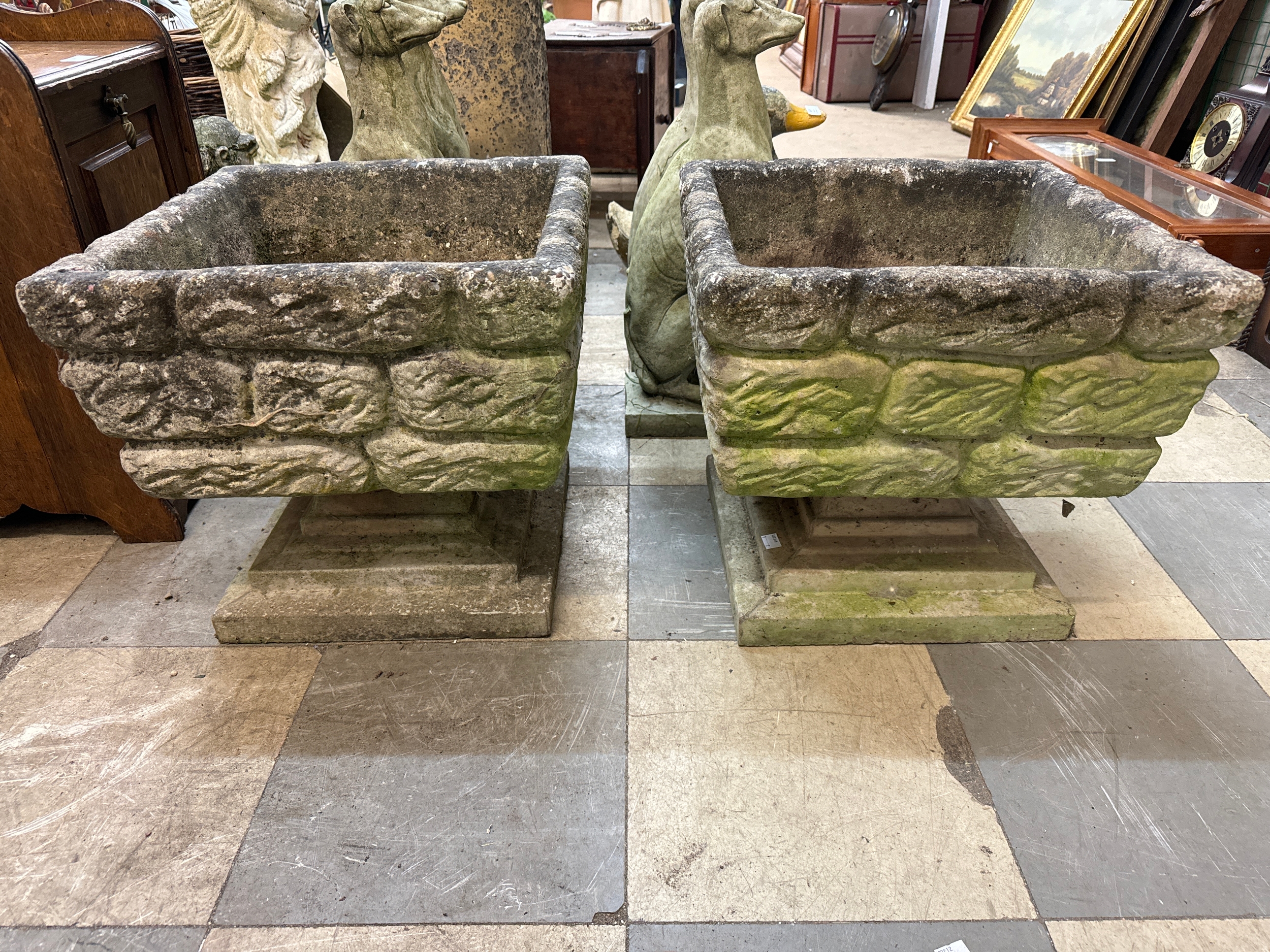 A pair of square concrete garden planters