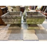 A pair of square concrete garden planters