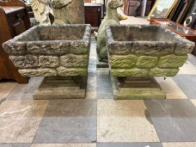 A pair of square concrete garden planters