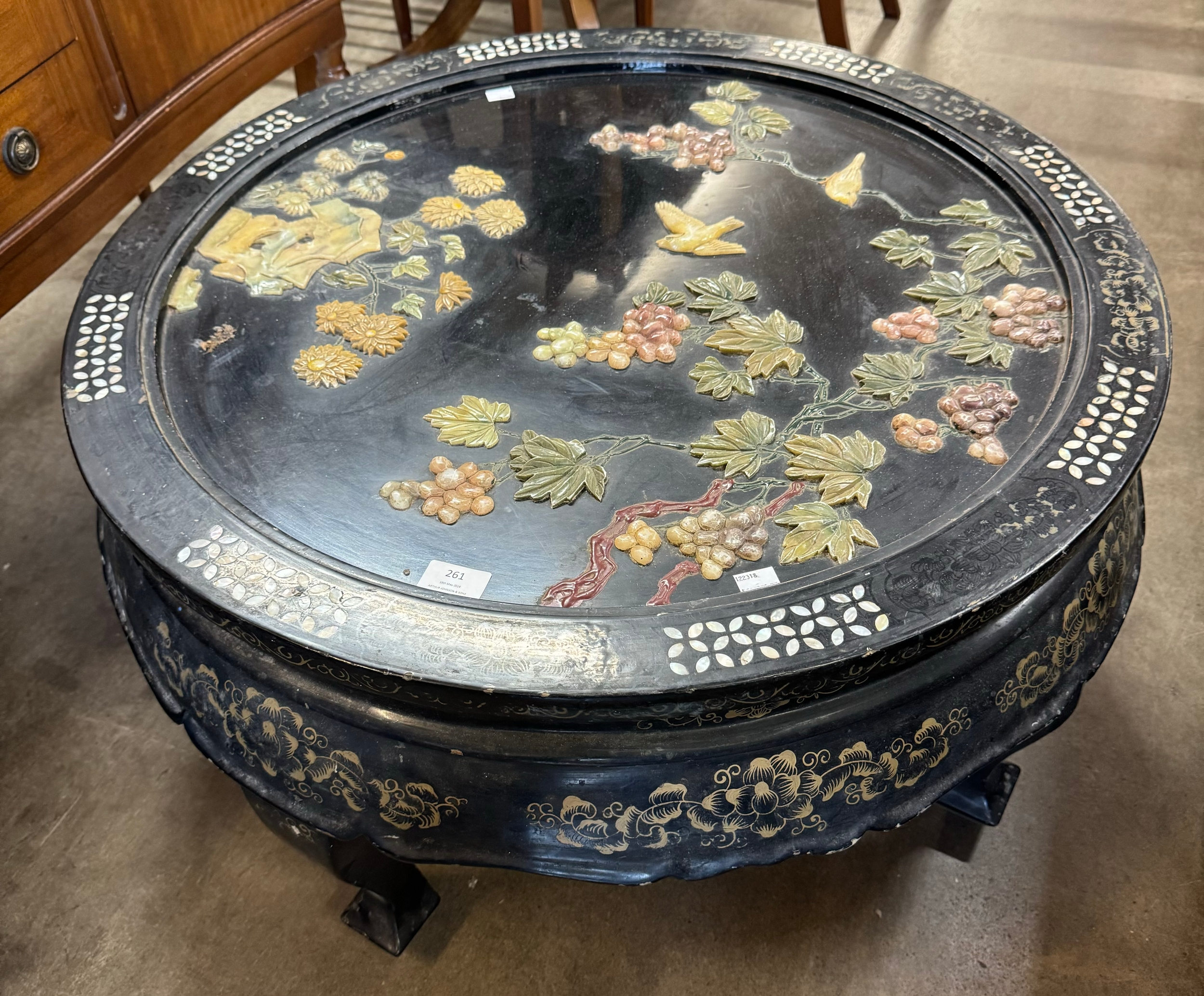 An oriental black lacquered chinoiserie circular coffee table