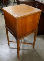 An early 20th Century oak sewing box on stand
