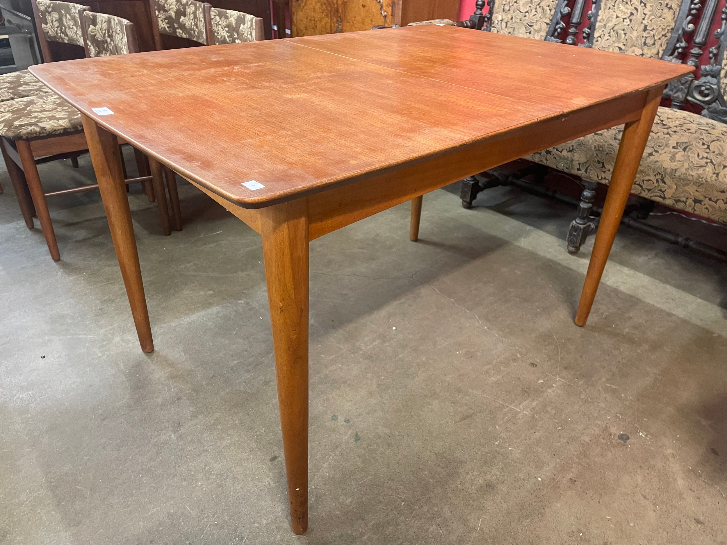 A teak extending dining table