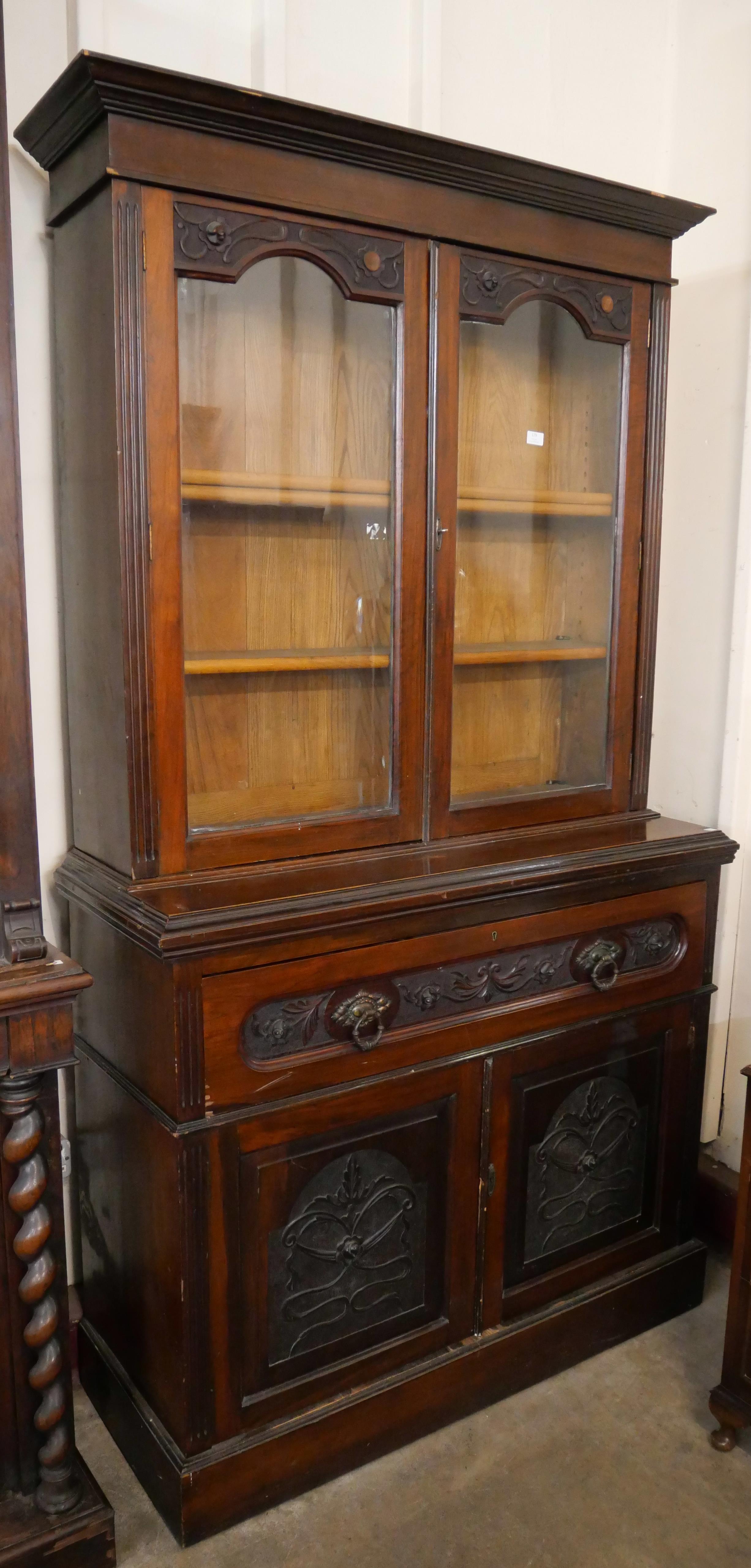 An Edward VII carved walnut secretaire bookcase